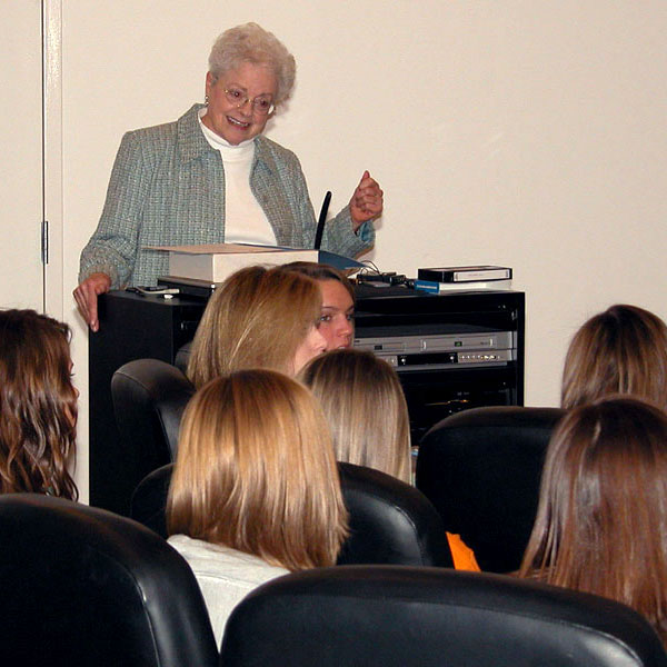 Jane Schulz speaks with a group of students